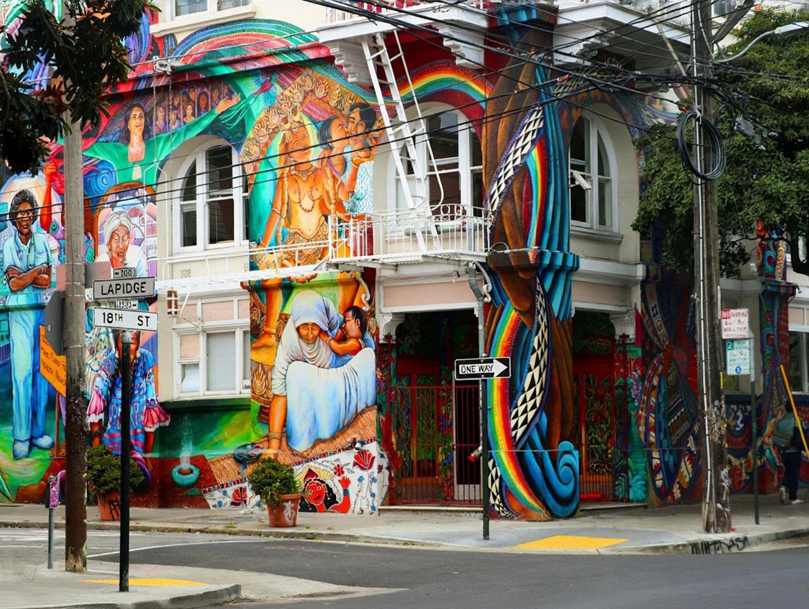 18th Street in Pilsen — murals that cover entire building faces, a few blocks from the tamale carts